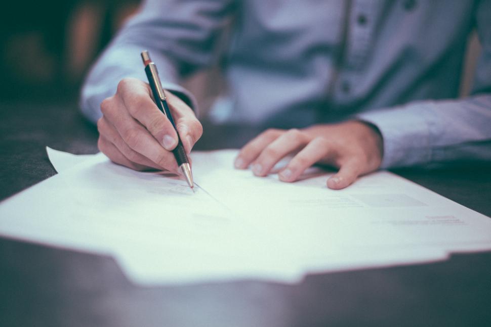 Image of Close up of a hand writing on paper